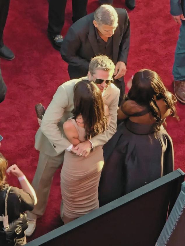 Brad Pitt is hugging Ines De Ramon very tightly.